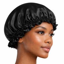 Load image into Gallery viewer, Black 100% mulberry silk bonnet with soft ruffle edge, worn as a silk sleeping cap to protect hair overnight