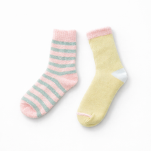 Load image into Gallery viewer, Fluffy bed socks shown inside and out, with one sock displaying the plush exterior and the other revealing the 100% pure silk lining inside.
